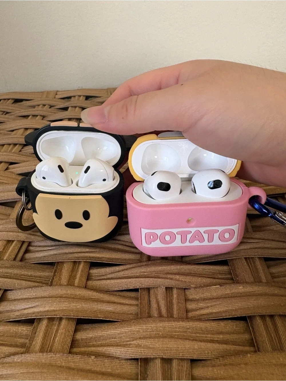 2 Apple AirPods with cases